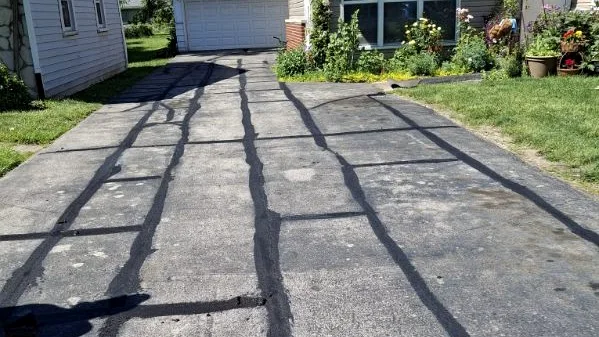 Crack sealing pattern on driveway before surface coating
